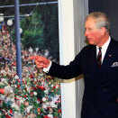 Prince Charles at the Nobel Peace Centre, where a picture of flowers layed down in memory of the victims of 22 July dominates one of the walls (Photo: Lise Åserud / Scanpix)